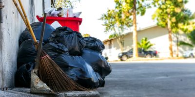 closeup black garbage bag with soft-focus and over light in the background